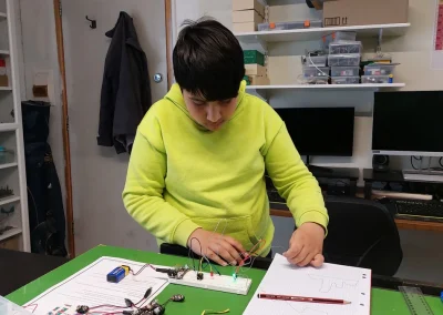 Student assembling electronic circuit