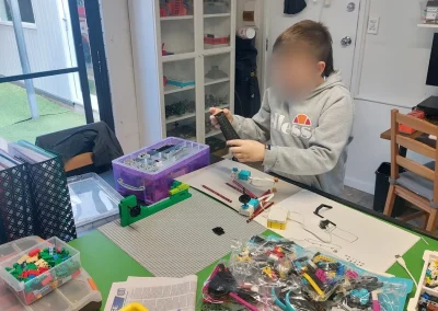 Student assembling lego robot