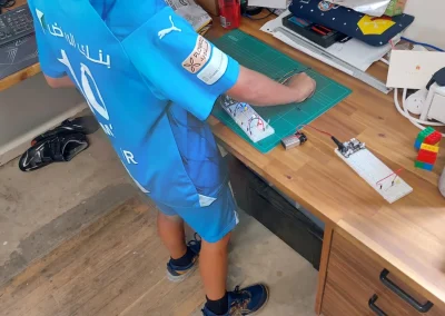 Student building cardboard electronics project