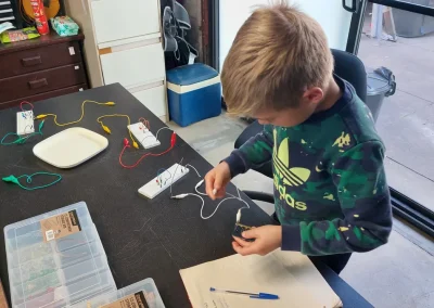 Student building simple electric circuit