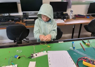 Student connecting electronics components