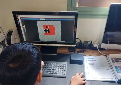 Student drawing pixel art game character