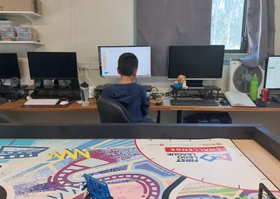 Student programming robot at computer